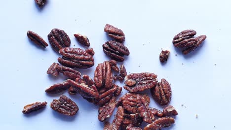 Slow-motion-of-pecan-nut-dropping-on-white-background