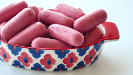 Mini-sausage-in-a-red--bowl-on-white