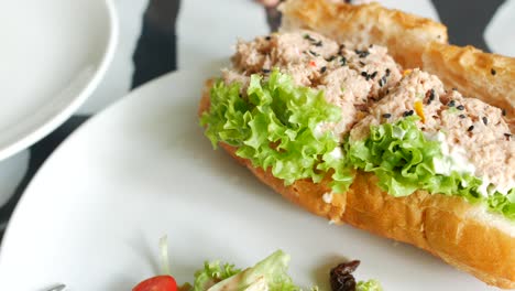 Tuna-sandwich-with-mayonnaise-on-a-plate-on-table