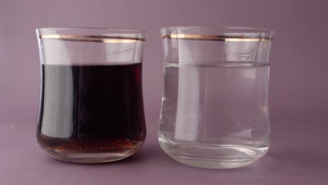 Comparing-soft-drinks-with-glass-of-water-on-table