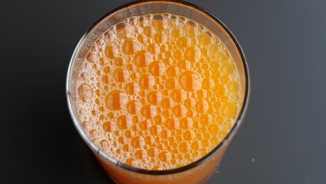 Orange-juice-in-glass-on-table-,