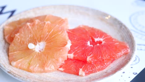 Eating-fresh-grapefruits-close-up-,