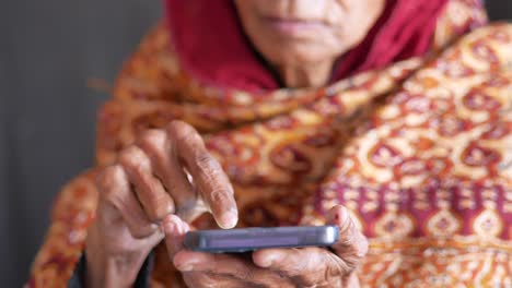 Senior-women-hand-using-smart-phone-close-up
