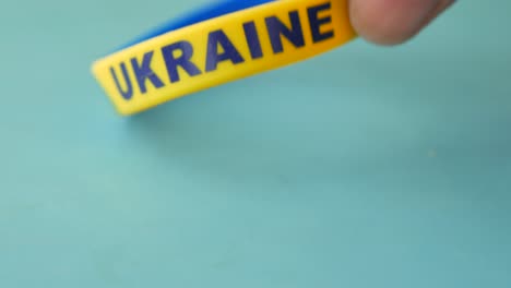 Hand-pick-blue-and-yellow-wristband-,-s-of-flag-of-ukraine
