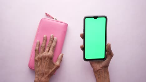 Senior-women-and-using-smart-phone-with-green-screen