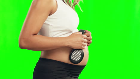 Close up of pregnant woman using headphones on her belly Stock Photo by  ©Dmyrto_Z 136380656