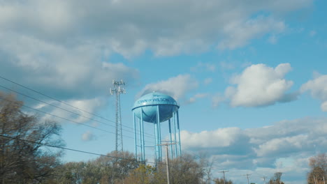 Wilson,-NY,-USA:-October-2021:-Tall-blue-water-tower.-View-from-the-car-window