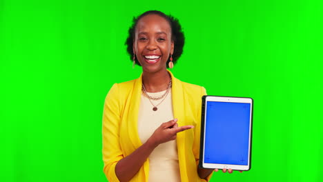 Woman,-pointing-and-tablet-by-green-screen