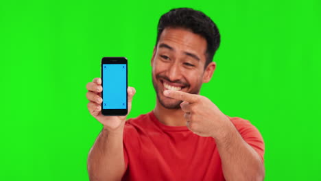 Man,-face-and-pointing-at-phone-by-green-screen