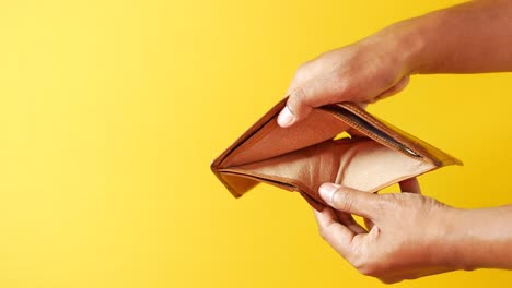 Man-hand-open-an-empty-wallet-with-copy-space