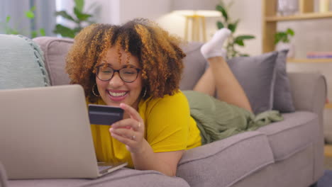 Laptop,-credit-card-and-woman-on-a-sofa