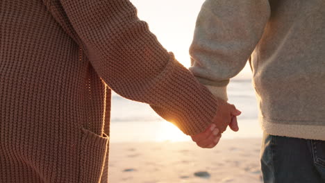 Love,-beach-and-senior-couple-holding-hands-by