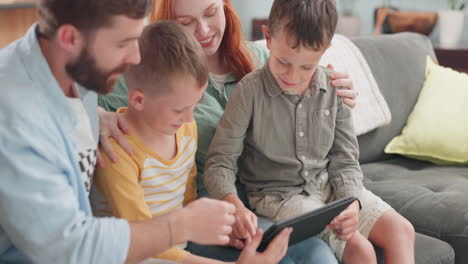 Parents,-children-and-tablet-in-family-home