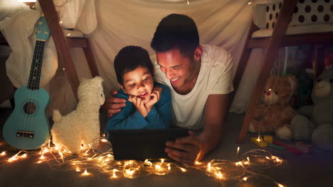Dad-and-child-at-night-on-tablet-in-tent-watching