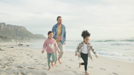 Family,-father-and-children-running-on-a-beach