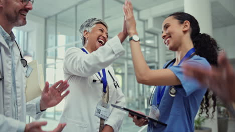 Clapping,-high-five-and-team-of-doctors-in-clinic