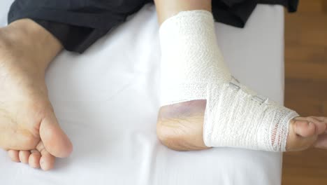 Woman-with-bandaged-foot-close-up-,