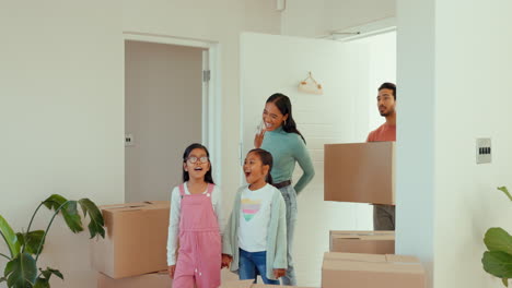 Parents,-kids-and-box-at-front-door-in-new-home