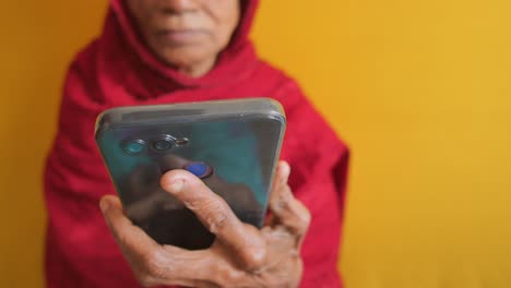 Senior-women-hand-using-smart-phone-close-up