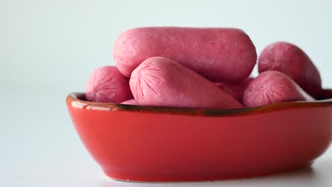 Mini-sausage-in-a-red--bowl-on-white