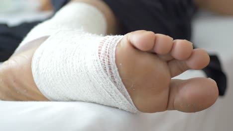 Woman-with-bandaged-foot-close-up-,