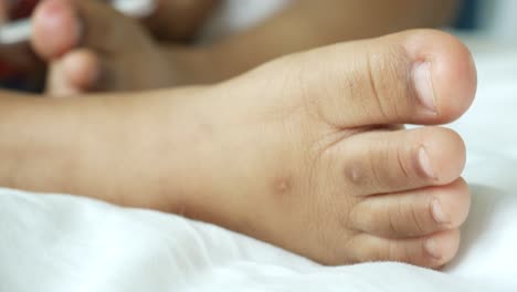 Close-up-of-5-years-old-child-dry-feet-on-bed