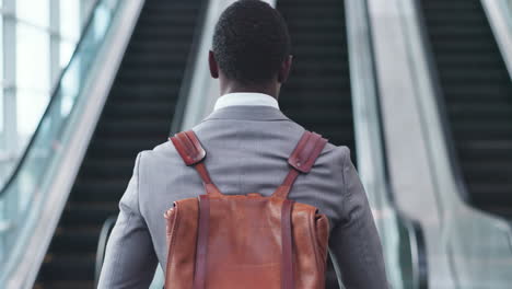 Back,-businessman-and-walking-to-escalator