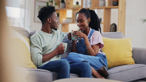Coffee,-talking-and-a-happy-black-couple-on-a-sofa