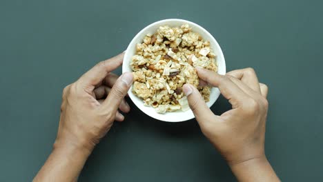 Hand-pick-granola-musli-from-a-bowl