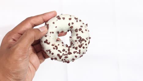 Close-up-of-hand-holding-donuts