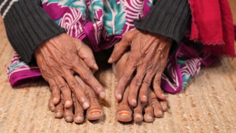 Close-up-on-senior-women-feet-and-hand-massage-on-injury-spot