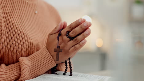 Praying-hands,-rosary-and-woman-with-bible-at-home