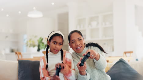 Playing-video-game,-mother-or-daughter-on-sofa