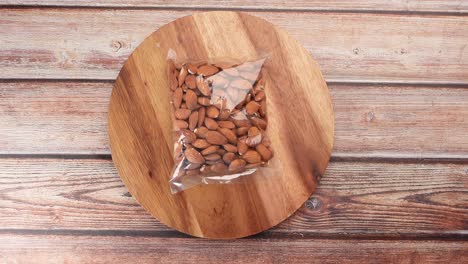 Top-view-of-almond-nut-in-a-plastic-packet-on-table