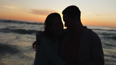 Beach-sunset,-kiss-and-relax-couple-silhouette