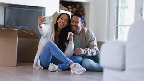 Selfie,-keys-and-moving-with-couple-in-new-house