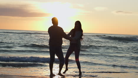 Happy,-sunset-and-silhouette-of-couple-at-beach