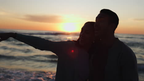 Beach-sunset,-silhouette-and-couple-hug