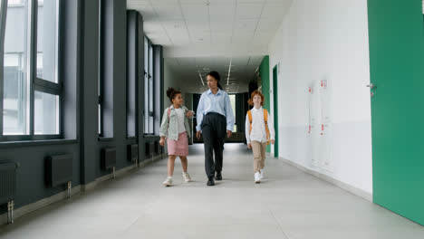Teacher-and-pupils-walking-through-the-corridor.
