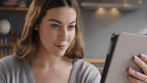 Happy-beautiful-woman-using-digital-tablet-browsing-the-internet-staying-connected-at-home