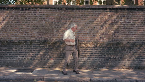 Contemporary-funky-elderly-man-street-dancer-dancing-freestyle-in-the-city