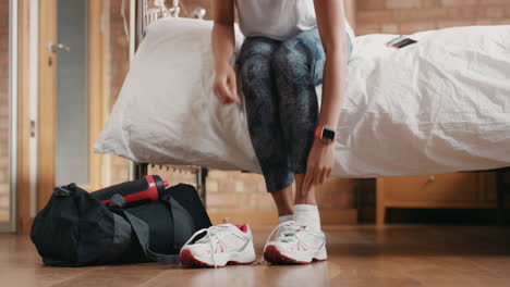 Healthy-woman-at-home-getting-ready-for-gym-workout-with-smart-watch