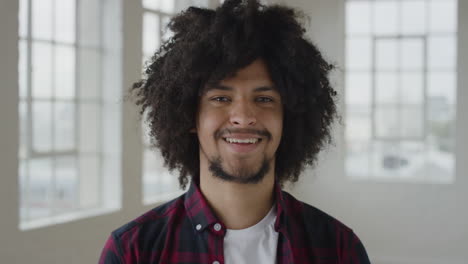 portrait-of-young-mixed-race-student-man-smiling-cheerful-looking-at-camera-enjoying-independent-lifestyle-in-apartment-trendy-afro-hairstyle