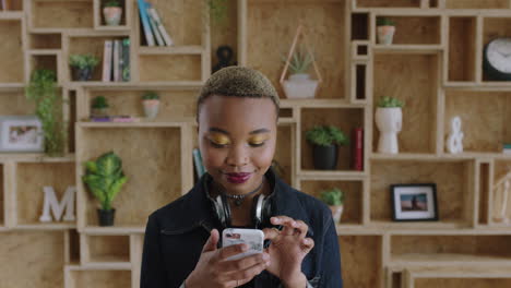 portrait-of-independent-young-african-american-woman-texting-browsing-using-smartphone-smiling-connected
