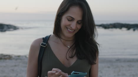 portrait-of-lovely-elegant-woman-texting-using-smartphone-on-beautiful-calm-beach