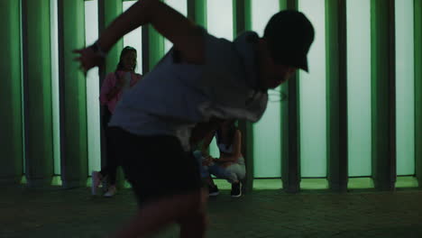 Hombre-Bailando-Joven-Bailarín-Callejero-De-Raza-Mixta-Breakdance-Movimientos-De-Estilo-Libre-Amigos-Viendo-Aplausos-Disfrutando-Pasar-El-Rato-En-La-Ciudad-Por-La-Noche