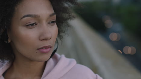 close-up-portrait-beautiful-mixed-race-woman-wearing-earphones-enjoying-listening-to-music-looking-pensive-calm-wind-blowing-afro-hairstyle