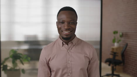 portrait-of-young-african-american-businessman-smiling-enjoying-successful-start-up-business-confident-entrepreneur-in-modern-office-workspace