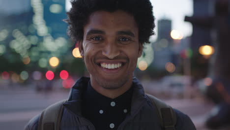 close-up-portrait-of-handsome-young-mixed-race-man-smiling-cheerful-at-camera-enjoying-calm-urban-evening-in-city-commuting-travel