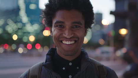 close-up-portrait-of-handsome-young-mixed-race-man-laughing-cheerful-at-camera-enjoying-calm-urban-evening-in-city-commuting-travel